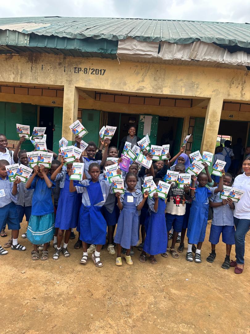 Pupils displaying educational materials received through ASF support